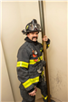 Belmont Firefighter Stands Next to Fire Pole