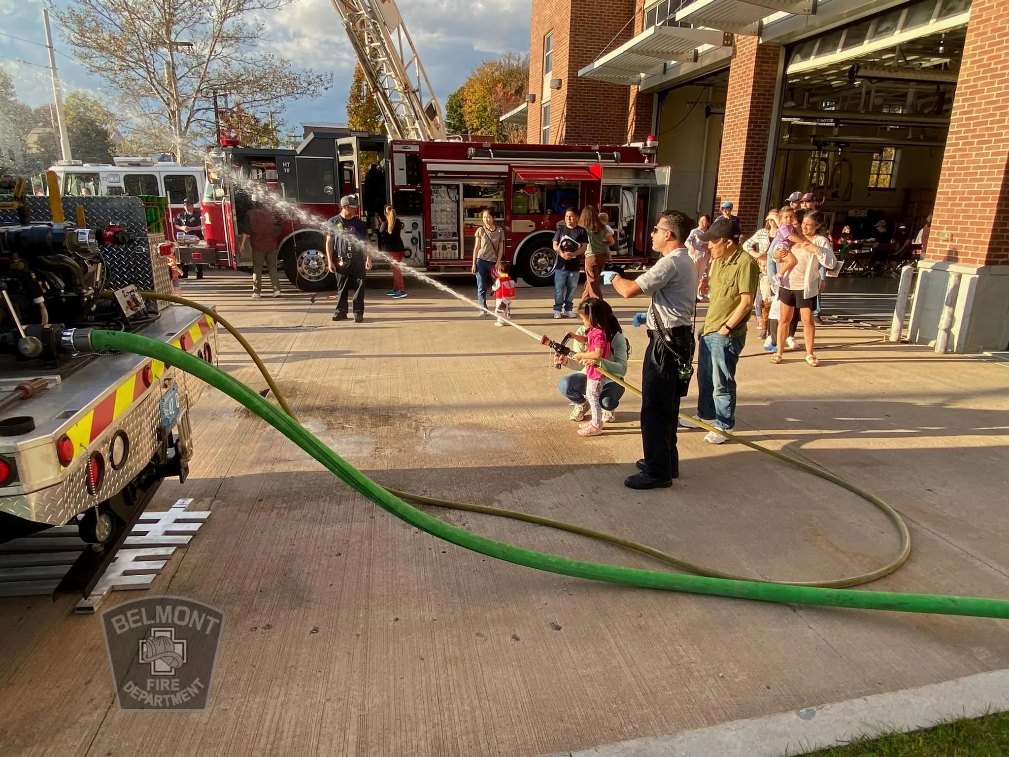 Little Girl Gets to Try out Fire Hose at a Fire Department Community Day